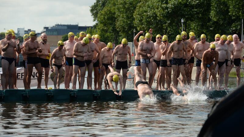 Participants make a splash at the Liffey Swim in Dublin on Saturday. Photograph: Dara Mac Donaill/The Irish Times.