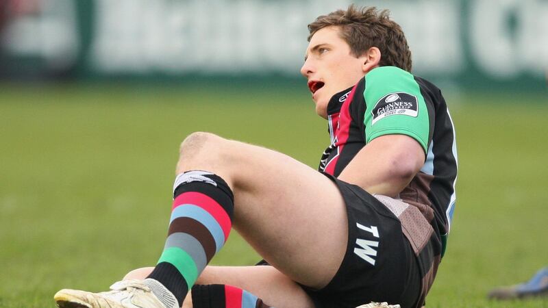 Tom Williams of Harlequins goes to ground having bitten into a fake blood capsule in his mouth. Photograph: Warren Little/Getty Images