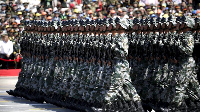 Soldiers of China’s People’s Liberation Army march past Tiananmen Gate during a military parade