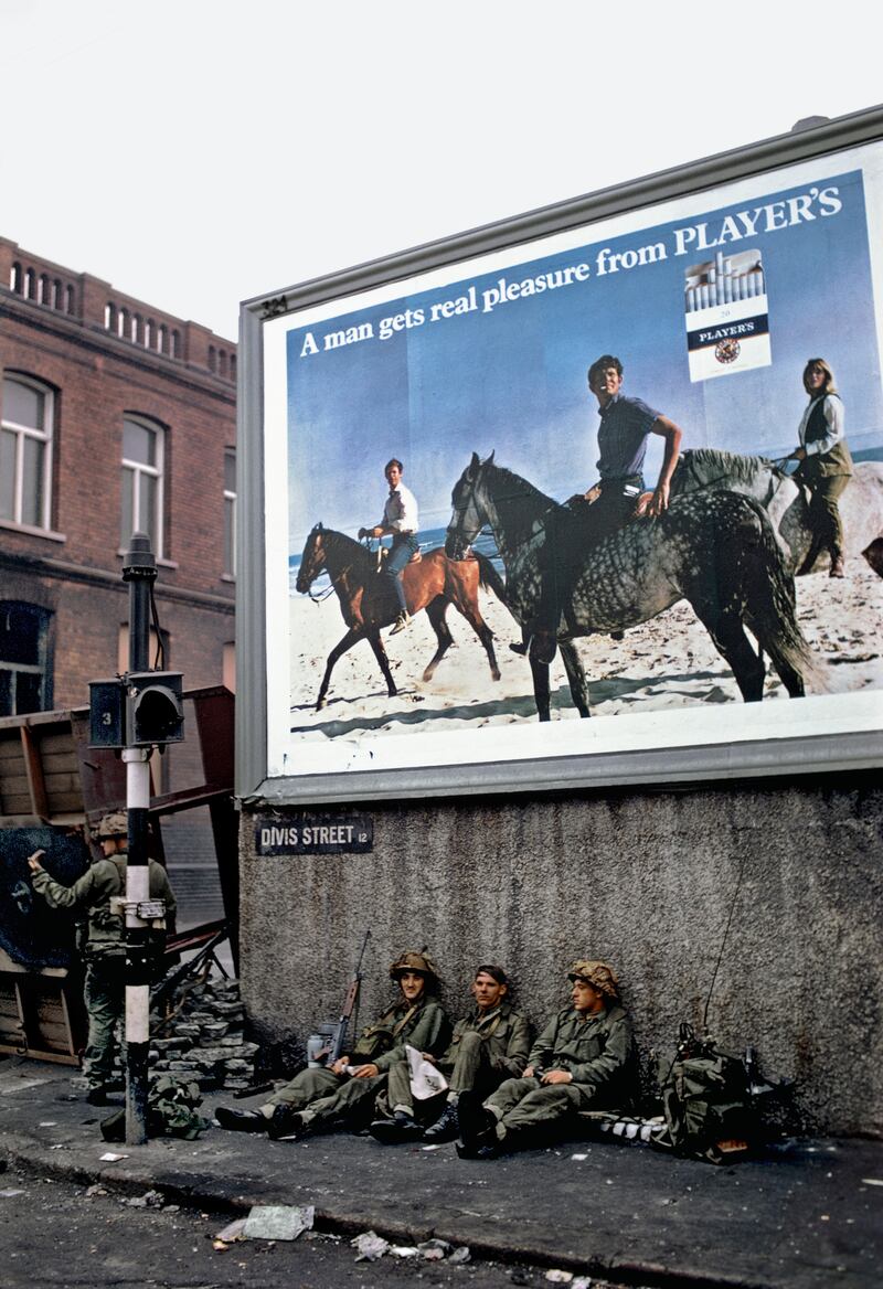 British soldiers res at a wall on Divis Street, west Belfast around 1969.