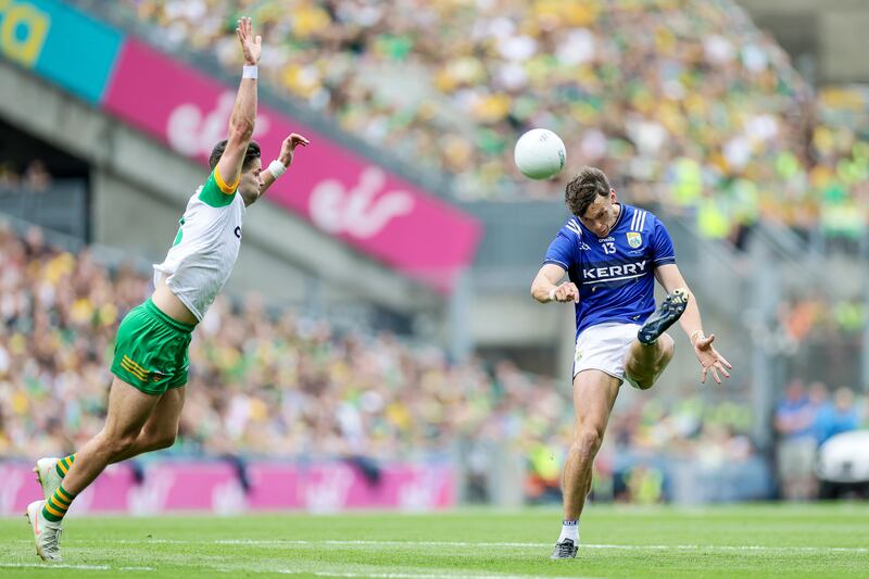 Kerry's David Clifford kicks a two-pointer despite the efforts of Brendan McCole of Donegal. Photograph: Laszlo Geczo/Inpho
