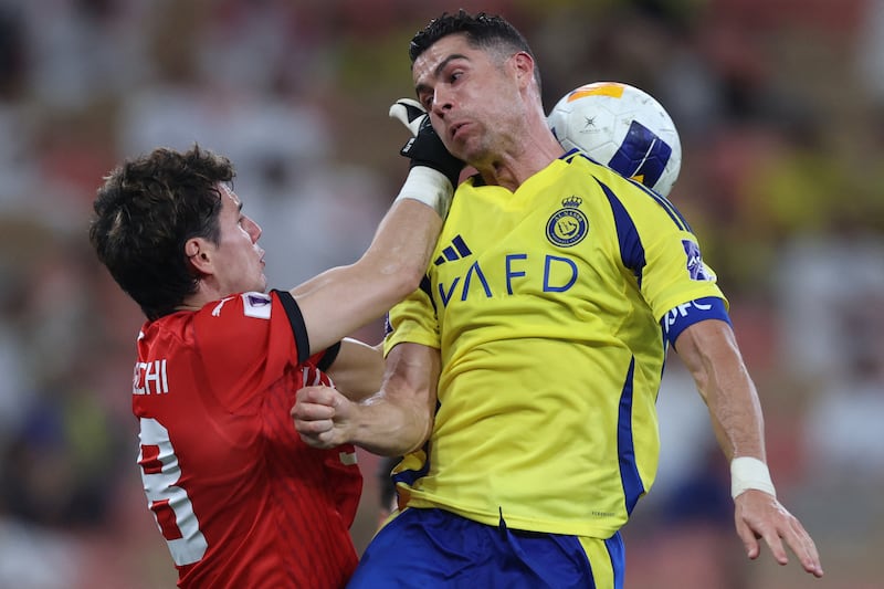 Kawasaki's Japanese goalkeeper Louis Yamaguchi fights for the ball with Nassr's Portuguese forward Cristiano Ronaldo. Photograph: AFP via Getty