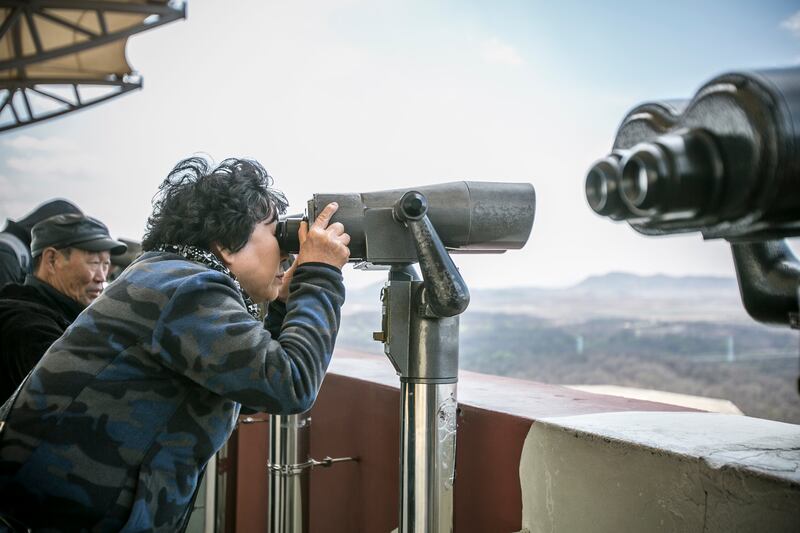 Tourists look towards the Kaesong Industrial Complex in North Korea from Dora Observatory in the DMZ. Photograph: Jean Chung/Getty 