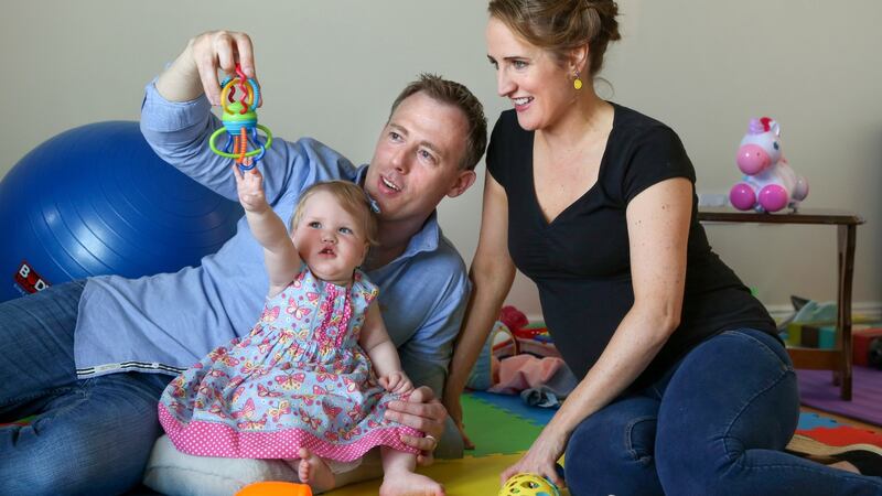 Séamus and Hazel Hughes  playing with their daughter Saorla at their home in Barna, Co Galway. Photograph: Joe O’Shaughnessy