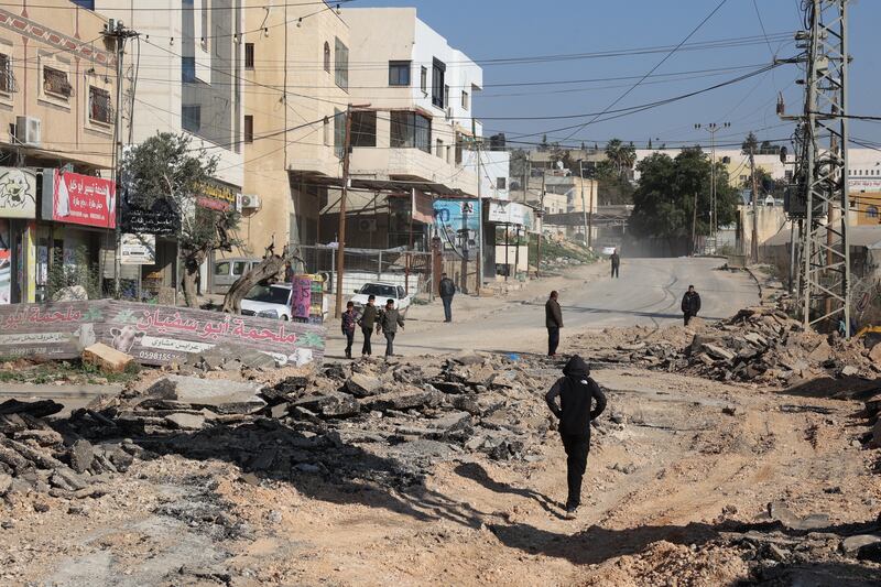 Palestinians walk on an unearthed road after a raid by Israeli forces, in the Fara camp for Palestinian refugees near Tubas in the north of the occupied West Bank on Tuesday. Photograph: Zain Jaafar/AFP via Getty