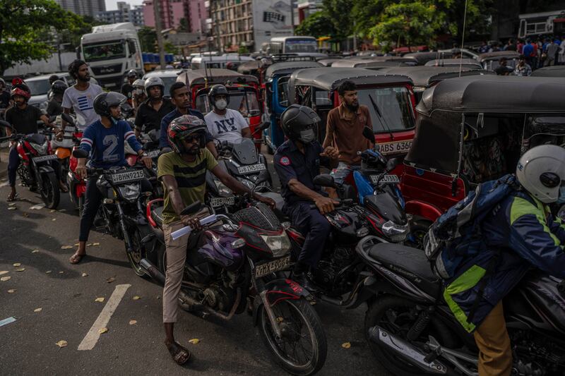 Sri Lankans wait in queue to buy petrol at a fuel station, in Colombo. Photograph: AP