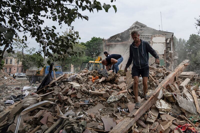 Local residents search the debris of a destroyed apartment after Russian shelling in Chuhuiv, Kharkiv region. Photograph: AP
