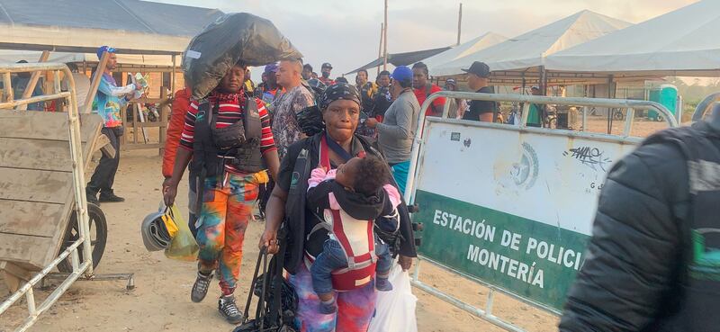 Migrants queueing and boarding ferries in Necoclí. Photograph: Peter Murtagh