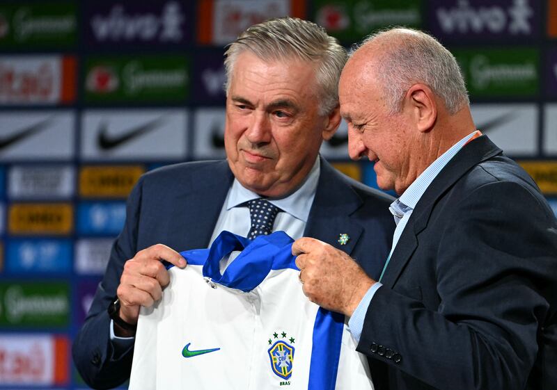 Carlo Ancelotti (left) receives the team's jacket from former Brazil head coach Luiz Felipe Scolari. Photograph: Mauro Pimentel/AFP via Getty Images