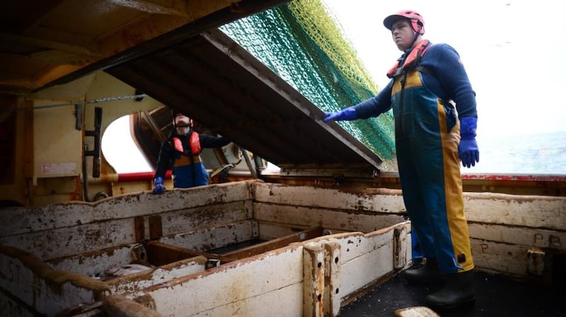 Crew members Conor Lynch and Shane Harrington at work on board the fishing vessel Eblana. Photograph: Bryan O’Brien