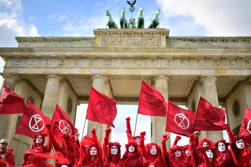 FORETELLING OF THE APOCALYPSE: Red Rebel Brigade activists, part of the Extinction Rebellion global movement, perform in front of the Brandenburg Gate in Berlin, Germany. The climate-crisis movement has planned a "spring rebellion" this week, including marches aimed at blocking traffic in major cities. Photograph: Clements Bilan/EPA