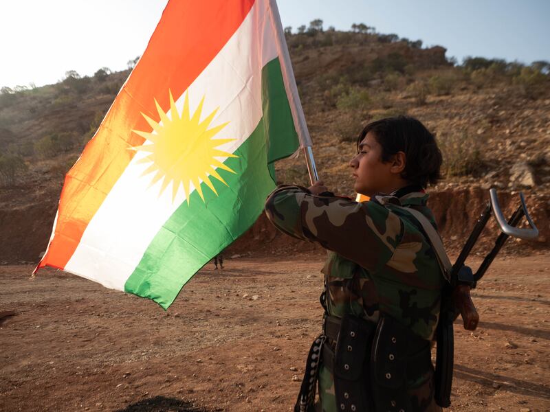 A militant from Iranian Kurdistan with the flag of Kurdistan. Photograph: Lorraine Mallinder
