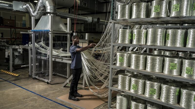 Drawing together strengthening fibres for a ‘pultrusion’.