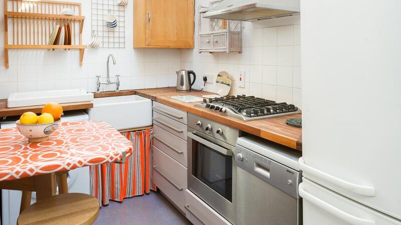 The small galley kitchen at 2 Eden Road Lower in Glasthule is lit from above by a Velux window.