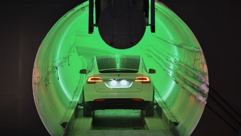 A modified Tesla Model X electric vehicle enters a tunnel before an unveiling event for The Boring Company Hawthorne test tunnel. Photograph:  Robyn Beck-Pool/Getty Images