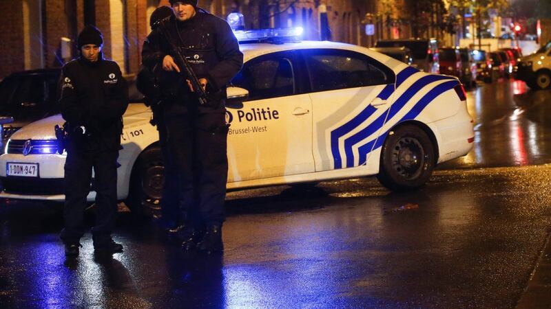 Police officers investigate the scene in the streets of Molenbeek, Brussels, Belgium on Saturday. Photograph: Olivier Hoslet/EPA
