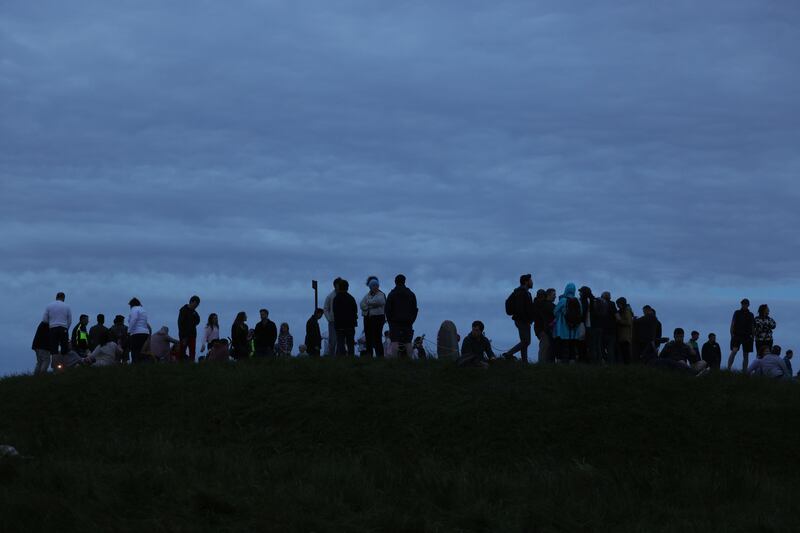 Visitors under the moonlight on the Hill of Tara. Photograph: Alan Betson