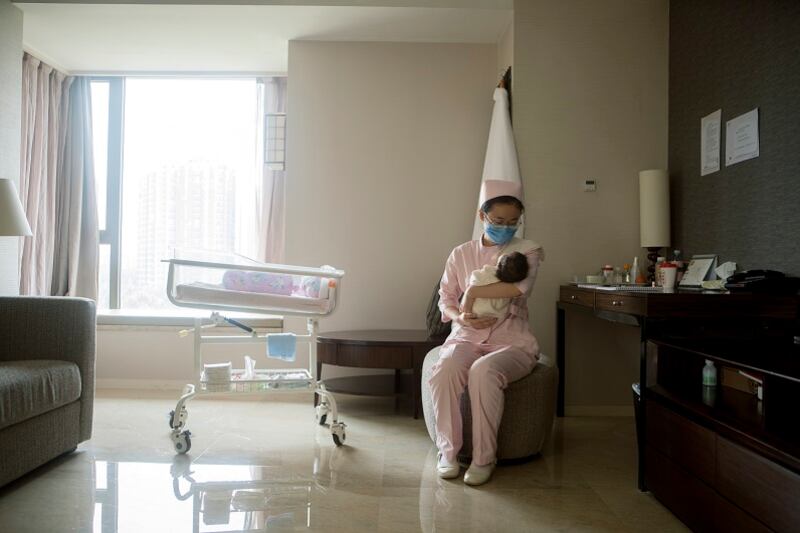 A nurse taking care of a newborn this month in Beijing. Almost three years after easing its “one child” policy, the Chinese government is trying to stimulate a baby boom.
