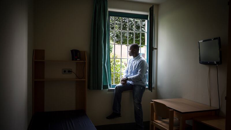 Harry Sarfo looking out a window inside the maximum-security prison in Oldenburg, Germany. Photograph: Gordon Welters/New York Times