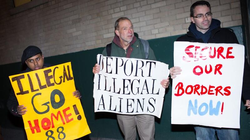 Jim MacDonald (centre) and fellow activists from the organisation New Yorkers for Immigration Control and Enforcement  protest outside the New York offices of 32BJ SEIU, a workers’ union, during a viewing party for US President Barack Obama’s speech on evecutive action immigration policy reform last night. Photograph: Kevin Hagen/Getty Images