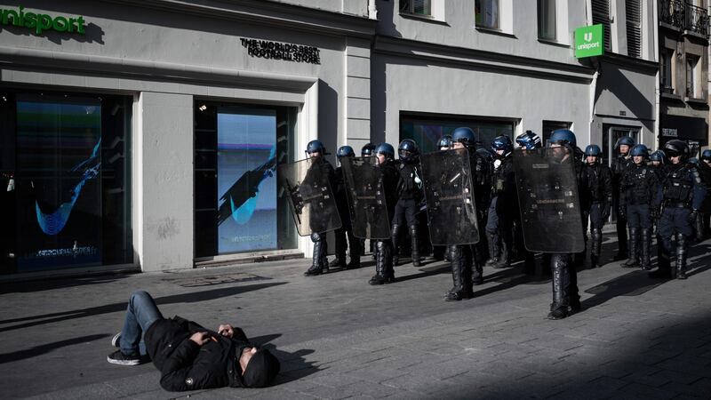 A yellow-vest demonstrator on the ground before riot mobile gendarmes in the shopping district of the Halles in Paris on Sunday. Photograph: Getty