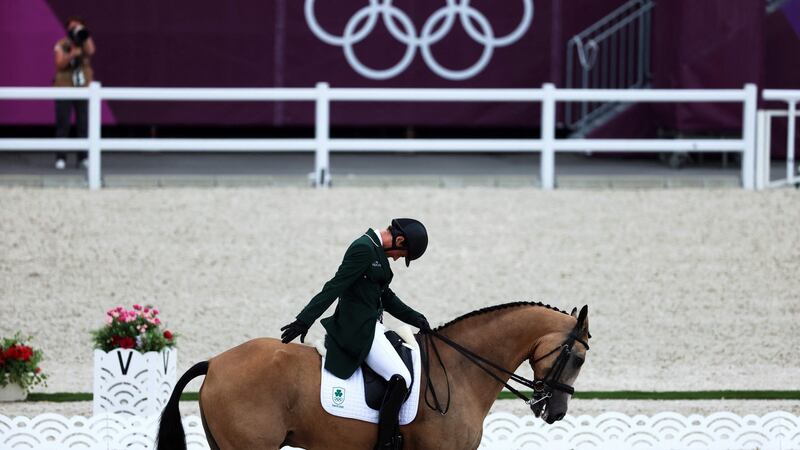 Ireland’s Sam Watson riding Flamenco salutes the judges at the end of his performance in the equestrian eventing individual dressage. Photo: Behrouz Mehri/AFP via Getty Images