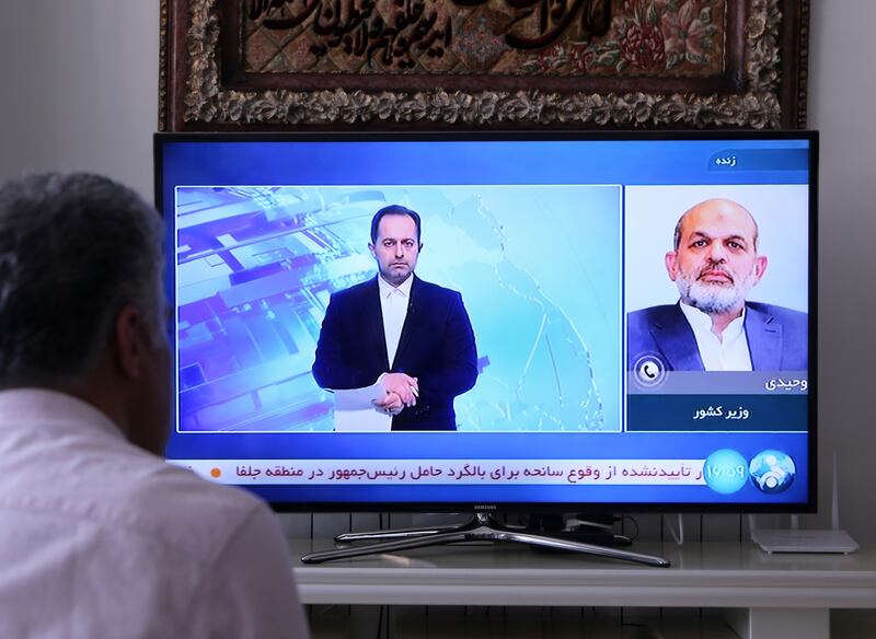 Citizens follow the news as Iranian interior minister Ahmad Vahidi comments after a helicopter in Iranian president Ebrahim Raisi's convoy crashed on Sunday. Photograph: Fatemeh Bahrami/Anadolu via Getty Images