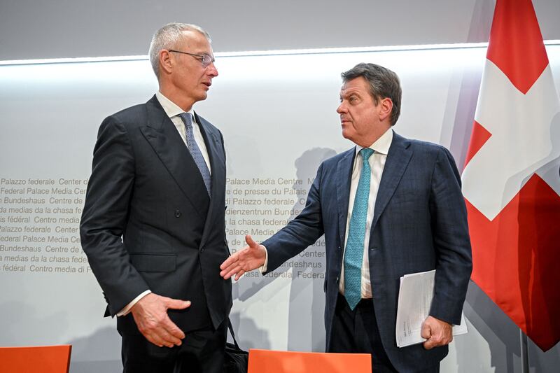 UBS Chairman Colm Kelleher (R) shakes hands with Credit Suisse chairman Axel Lehmann (L) after a press conference in Bern last March. Photograph: Fabrice Coffrini/AFP via Getty Images