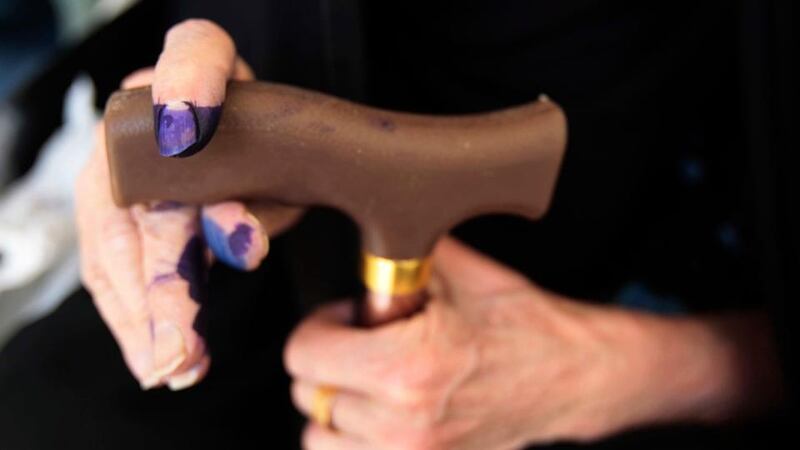 A woman with ink-stained fingers holds a walking stick at a polling station in Basra on Saturday. Voting was mainly peaceful in the local elections in spite of a spate of bombings that killed 60 and the assassination of 14 candidate ahead of the vote. Photograph: Reuters/Atef Hassan