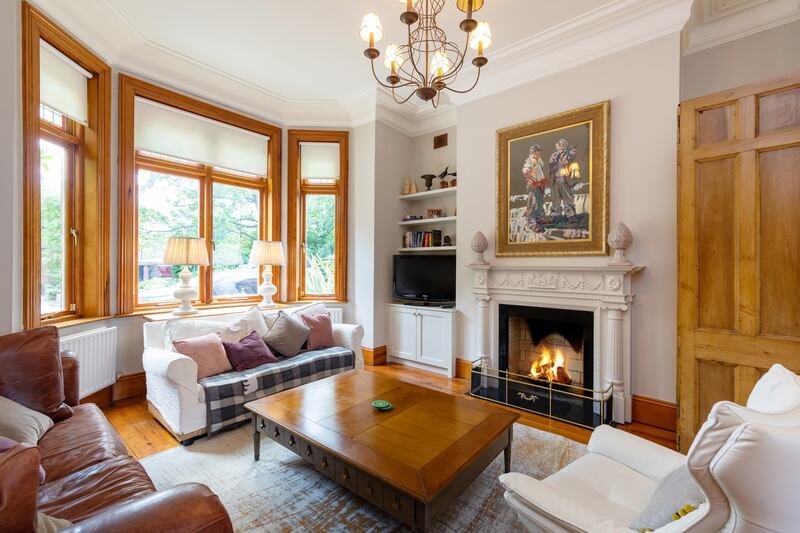 The rear reception rooms are elegant and softly formal, with elaborate ceiling roses, columns and marble fireplaces