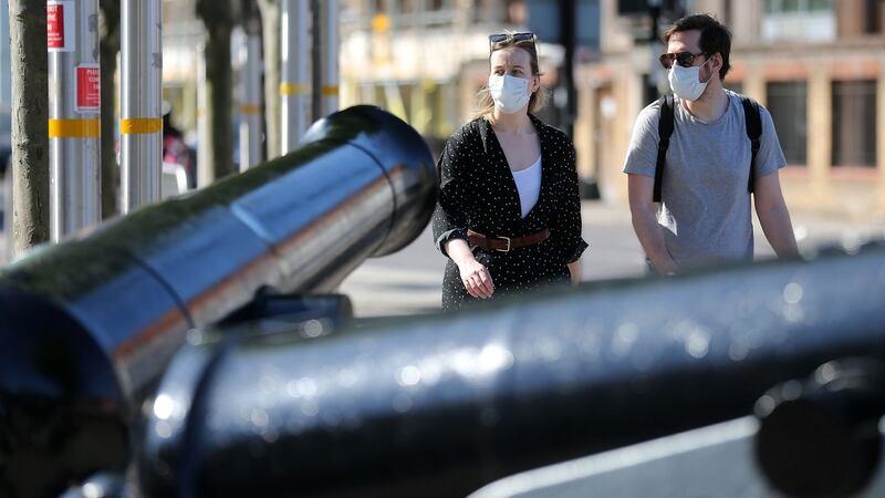 People wear PPE as they walk past Arsenal’s Emirates Stadium. Photograph:  Isabel Infantes/Getty/AFP