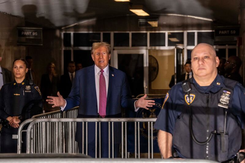 Former US president Donald Trump speaks to members of the press before entering the courtroom during his trial for allegedly covering up hush money payments linked to extramarital affairs, at Manhattan Criminal Court, New York City,  on Friday. Photograph: Mark Peterson/AFP/Getty