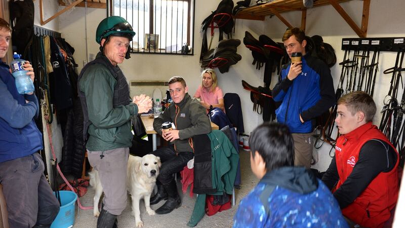 Jockey and trainer Johnny Murtagh, standing centre, chatting with his team at Fox Covert Stables in Co Kildare. Photograph: Dara Mac Dónaill