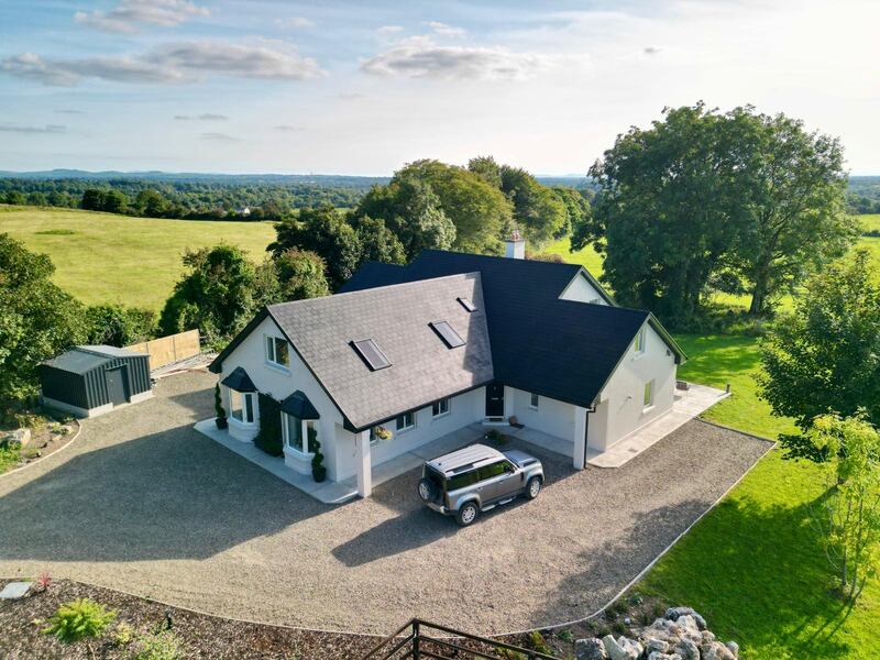 The property stands on 0.9 acres with ancient oak trees
