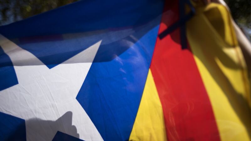 Supporters of Catalan independence wave a separatist flag during a demonstration outside the University of Barcelona in Barcelona on Fr5iday.  Photograph: Geraldine Hope Ghelli/Bloomberg