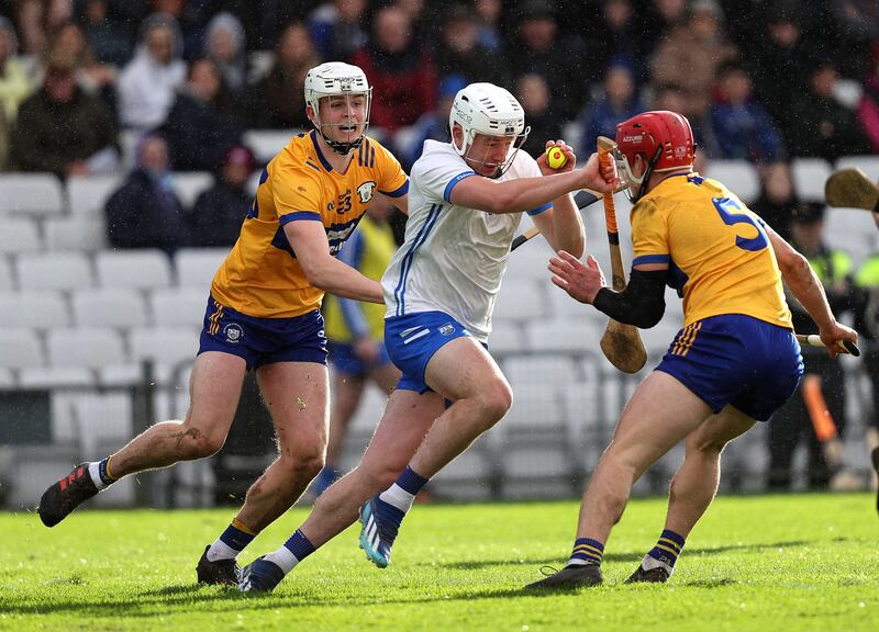 Waterford's Shane Bennett is tackled by Cian Galvin and John Conlan of Clare. Photograph: Bryan Keane/Inpho