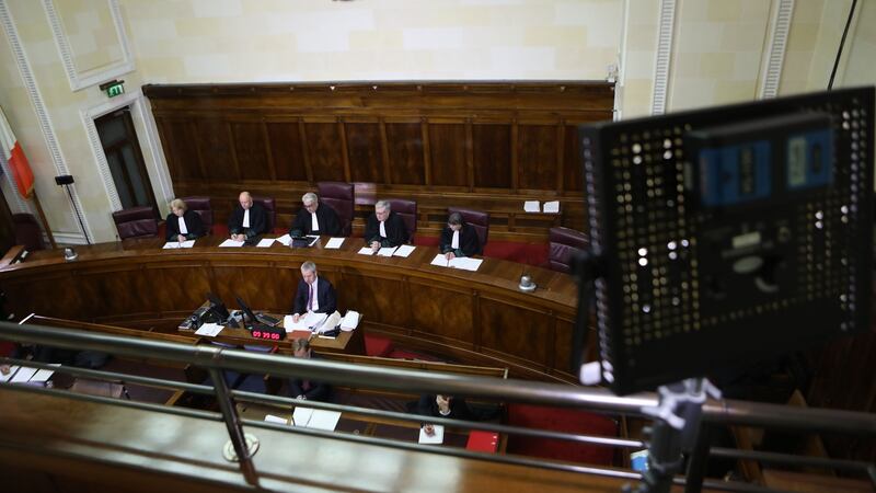 The view of the Supreme Court bench from behind one of the lighting stands in the public gantry during a live broadcast by RTE of two judgements. Photograph: Collins Courts