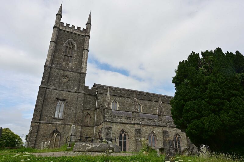 Down Cathedral and, in the foreground, the burial stone that marks the grave of St Patrick, St Brigid and St Columcille. Photograph: Arthur Allison/Pacemaker