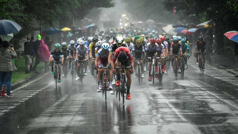 The pack rides in the rain during the second stage. Photograph: Getty Images
