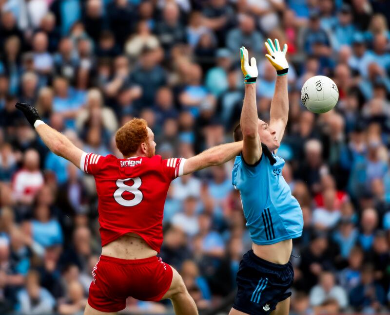 Dublin’s Peadar Ó Cofaigh Byrne and Derry’s Conor Glass compete in the air at Pairc Esler. Photograph: Evan Logan/Inpho