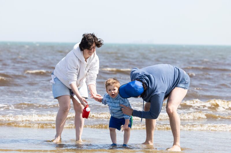 Clarissa and Roberto with their son Henrique (2) enjoying the sunshine on Dollymount Stand, Dublin on Wednesday. Photograph: Collins