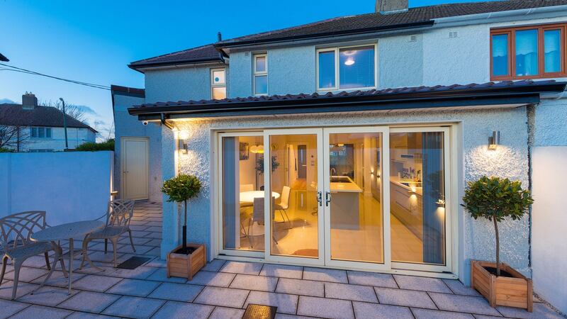 The kitchen is now a crisp eat-in space that overlooks the south-facing garden.