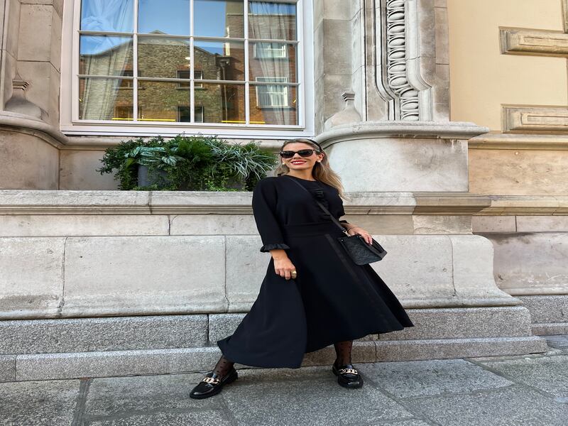 Black crepe Nova top with ruffle cuff detail €465, black crepe Camilla skirt with satin detail and high low hem €465