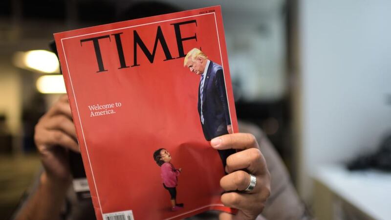 Cover story: the crying toddler, a superimposed Donald Trump towering over her, featured on the front of Time, under the headline “Welcome to America”. Photograph: Eric Baradateric/AFP/Getty