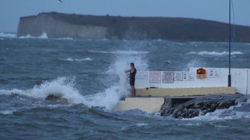 A man stands on Blackrock swimming tower in Salthill, Co Galway during Storm Callum. File photograph: Brian Lawless/PA Wire