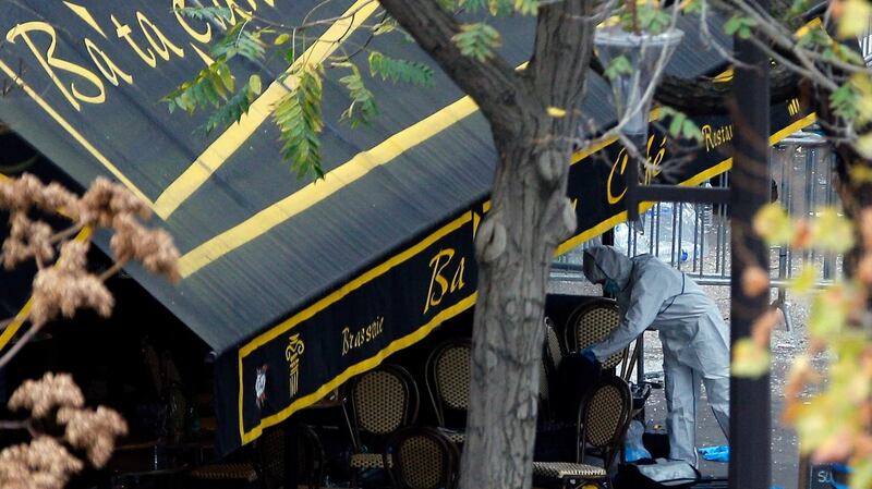An investigator works outside the Bataclan concert hall on Saturday. Photograph: Christophe Ena/AP Photo