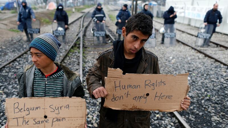 Migrant hold banners during a protest demanding the opening of the border between Greece and Macedonia. Photograph: AP