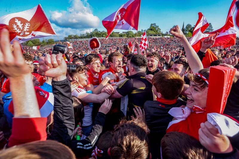 Derry's Brendan Rogers and Odhran Lynch celebrate after the Ulster SFC final win with supporters. Photograph: Tom Maher/Inpho
