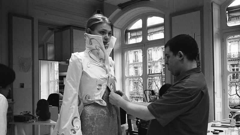 Alexander McQueen at a fitting. A trained tailor, he maintained that ‘I am here to abolish the rules but keep the traditions.’