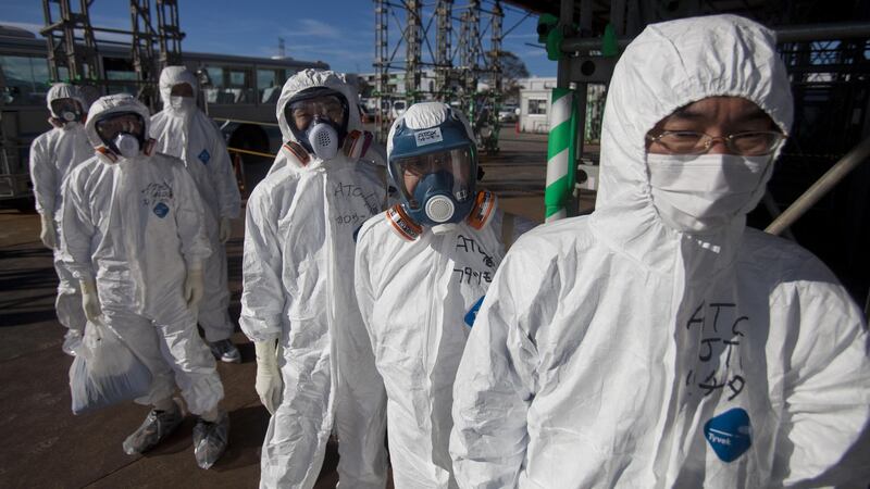 Danger zone: workers wait to enter the crippled plant in 2011. Photograph: David Guttenfelder/AFP/Getty Images